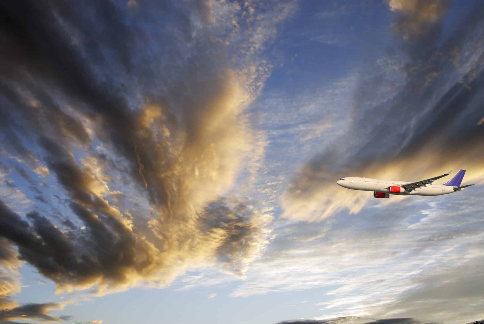 plane flying with clouds destination wedding videography