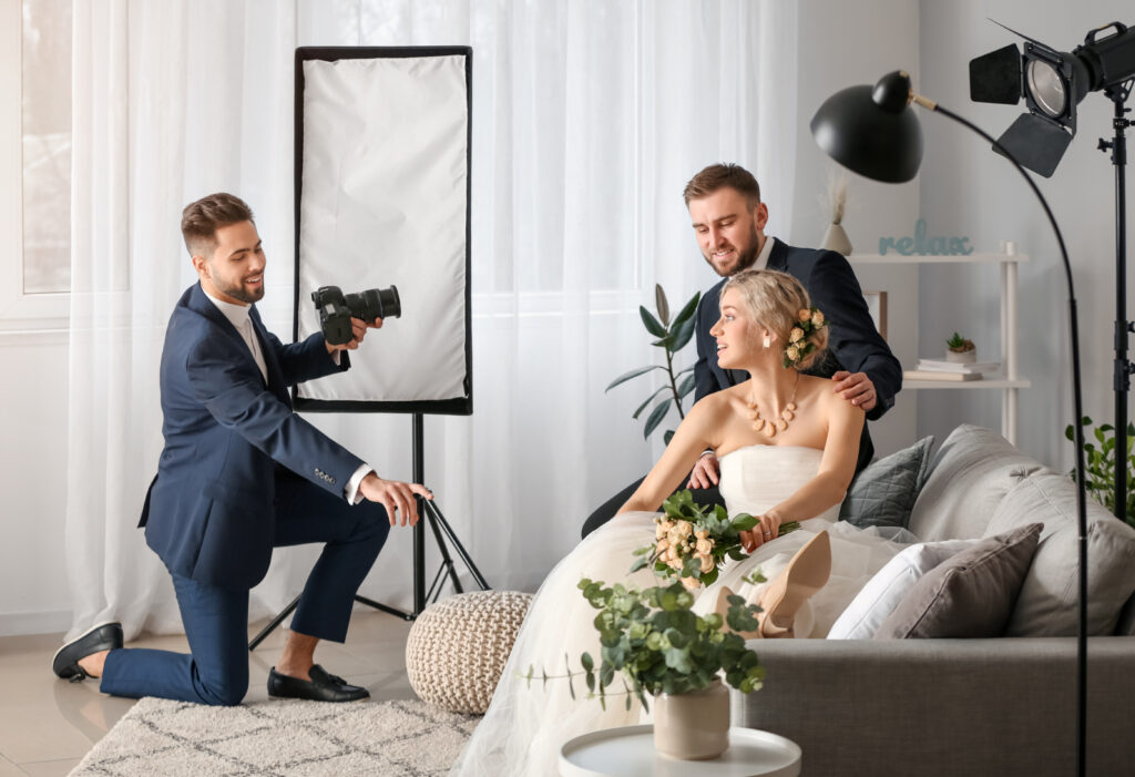 Second wedding photographer capturing bridal portraits from an alternate angle