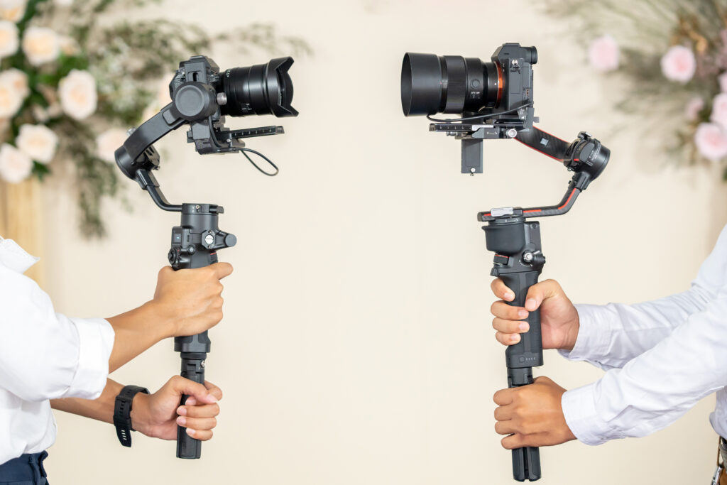 Second wedding videographer filming a wedding event
