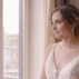 Humblebee Wedding Films Grace Portland Maine, bride looks out the window in her wedding gown