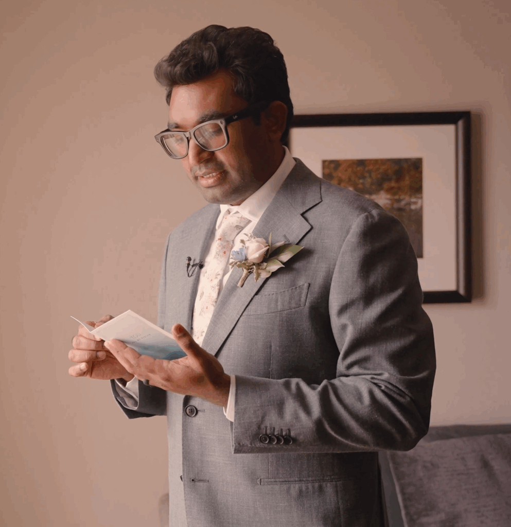 Humblebee Wedding Films Birch Wood Vineyards, a groom in a grey suit reads a letter from his soon to be wife
