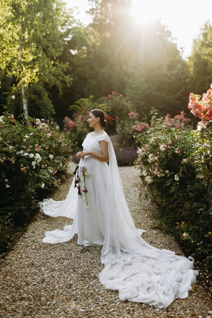 Humblebee Wedding Films Wedding Photography Styles, A stunning bride stands gracefully and elegantly amidst a vibrant and colorful garden, showcasing her beauty