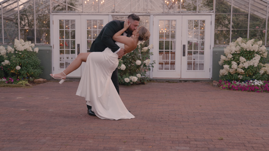 Couple dancing in a garden setting for documentary style wedding videography.
