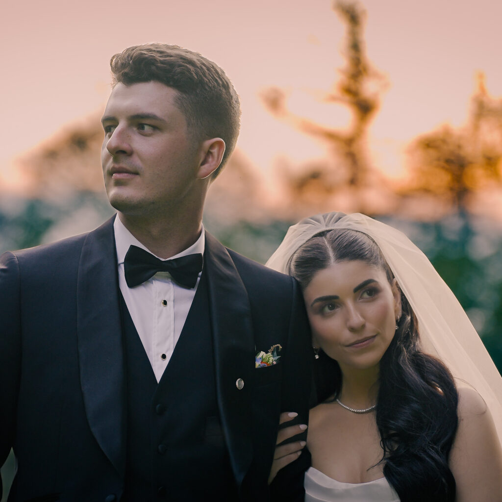 Elegant couple at outdoor wedding ceremony posing for documentary style wedding videography
