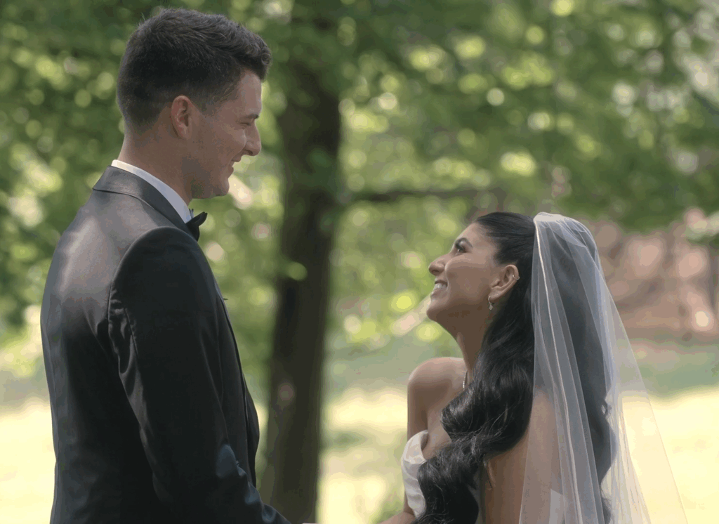 Humblebee Wedding Films Boston wedding content creator, newly weds stand before a large tree, smiling at each other