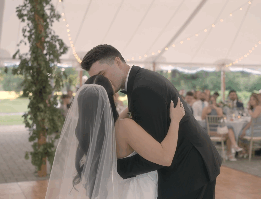 Humblebee Wedding Films Boston wedding content creator, newlyweds embrace and kiss at reception