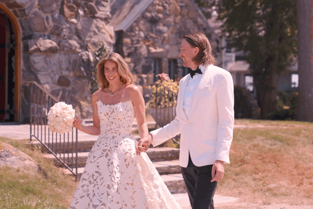 Humblebee Wedding Films Questions To Ask Wedding Videographer Questions To Ask Photographer & Videographer Newlywed couple walk hand in hand outside in front of a church