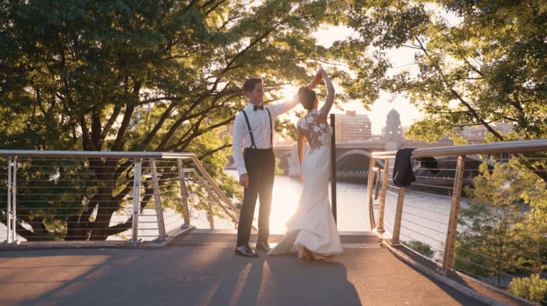 Humblebee Wedding Films Boston Wedding Photographers, newlyweds dance with Boston skyline behind them