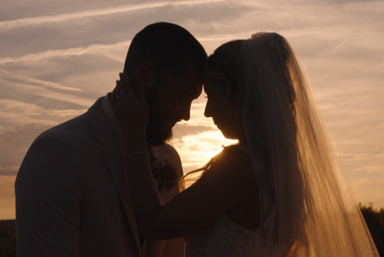 Wedding Videographers, silhouette of bride and groom with sun setting behind them